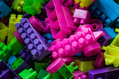 High angle view of multi colored toys on paper