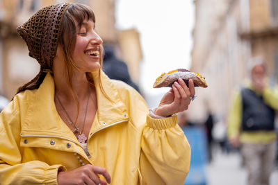 Young woman holding pineapple