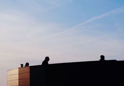Low angle view of silhouette man against sky
