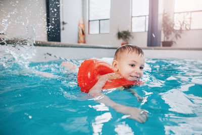 Portrait of boy swimming in pool