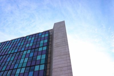 Low angle view of modern building against blue sky