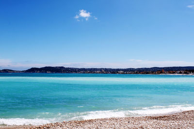 Scenic view of sea against blue sky