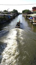 Boats in river with buildings in background