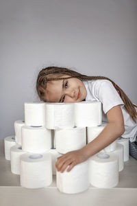 Portrait of mid adult woman sitting against white wall at home