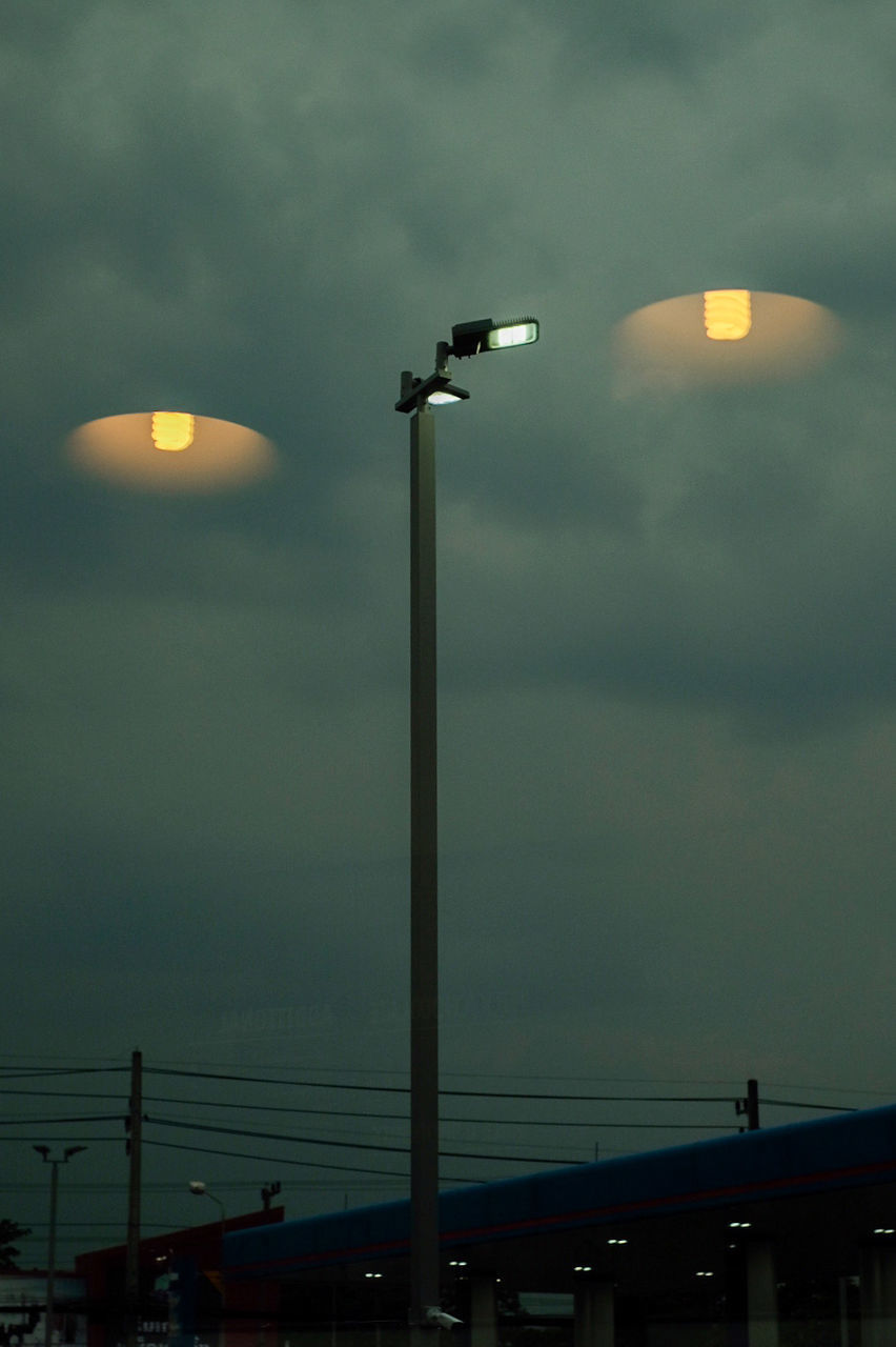 LOW ANGLE VIEW OF ILLUMINATED STREET LIGHTS AT NIGHT