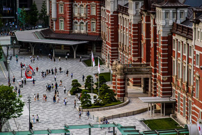 High angle view of people on street amidst buildings in city