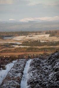 Scenic view of river against sky during winter