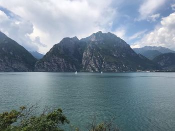 Scenic view of sea and mountains against sky