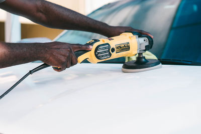 Cropped hand of man repairing car