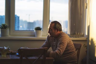 Man sitting on chair at home