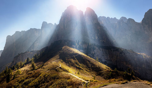 Panoramic view of sun shining over mountain