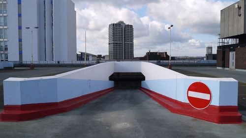 Entrance of underground parking lot against david murray john building in city