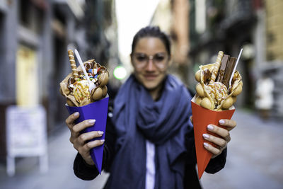 Portrait of woman holding ice cream