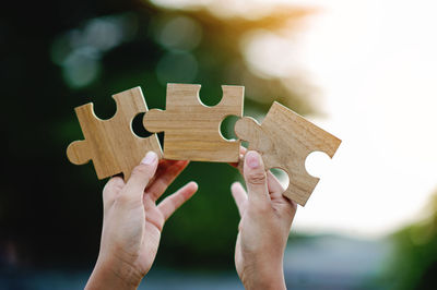 Cropped hand holding jigsaw puzzle