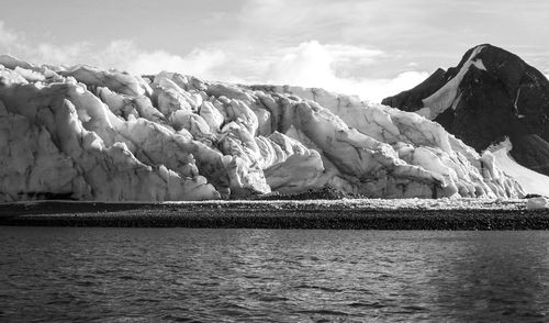 Black and white photo of glacier on beach in antarctica