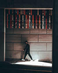 Full length of man standing by door of building