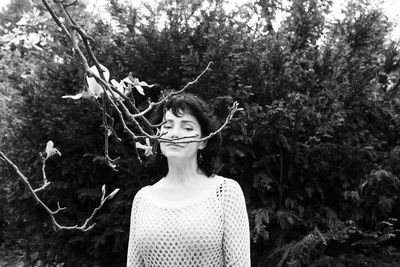 Smiling woman by plants looking away