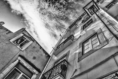 Low angle view of building against cloudy sky