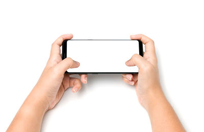 Midsection of person using mobile phone against white background