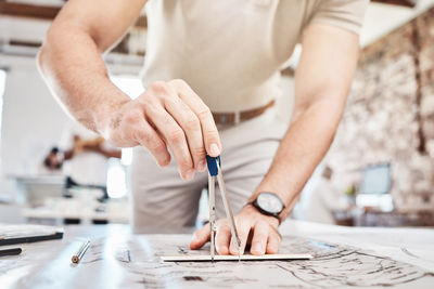 Midsection of man working at table