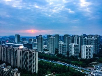 Illuminated cityscape against sky