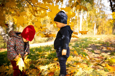 Side view of boy standing in park