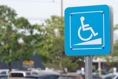 Blue accessibility sign in city