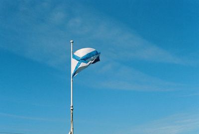 Low angle view of street light against blue sky