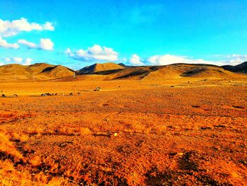 Scenic view of arid landscape against sky