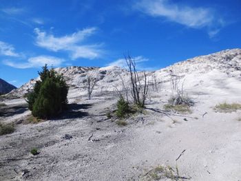 Scenic view of mountains against cloudy sky