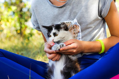 Midsection of woman holding cat