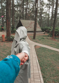 Rear view of person on footpath amidst trees