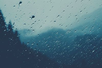 Full frame shot of wet glass window in rainy season