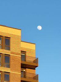 Low angle view of building against clear blue sky