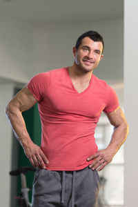 Muscular man standing in gym