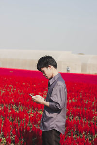 Full length of young man standing on field