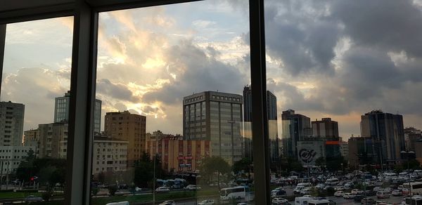 Buildings in city against sky during sunset