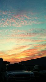 Cars against sky during sunset