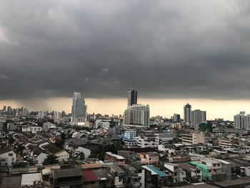 Aerial view of buildings in city against sky