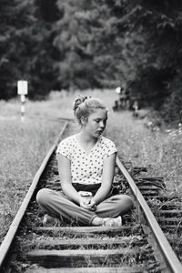 Full length of boy sitting on grass