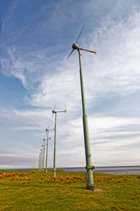 Windmill on field against sky