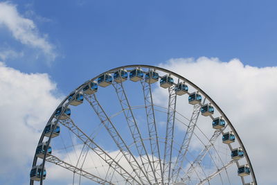 Low angle view of ferris wheel against blue sky