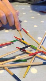 Cropped image of hand and pick up sticks