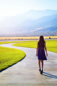 Rear view of woman standing on field