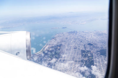 Aerial view of cityscape seen through airplane window