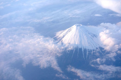 Low angle view of snowcapped mountain against sky