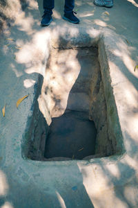 Low section of person standing in water