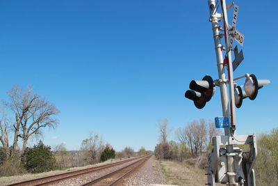 Railroad track against clear blue sky