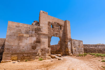 Old ruin building against blue sky