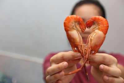 Close-up of woman making heat shape with shrimps